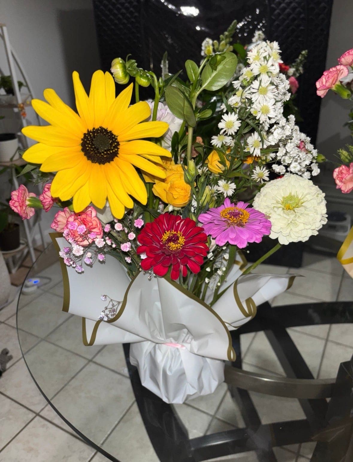 Birthday bouquet with a sunflower, red, magenta and white zinnias, pink carnations and white asters